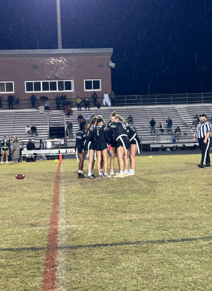 A pre-play huddle from a game against Apex High School. Photo used with the permission of Amelia Hokenberg ‘28)